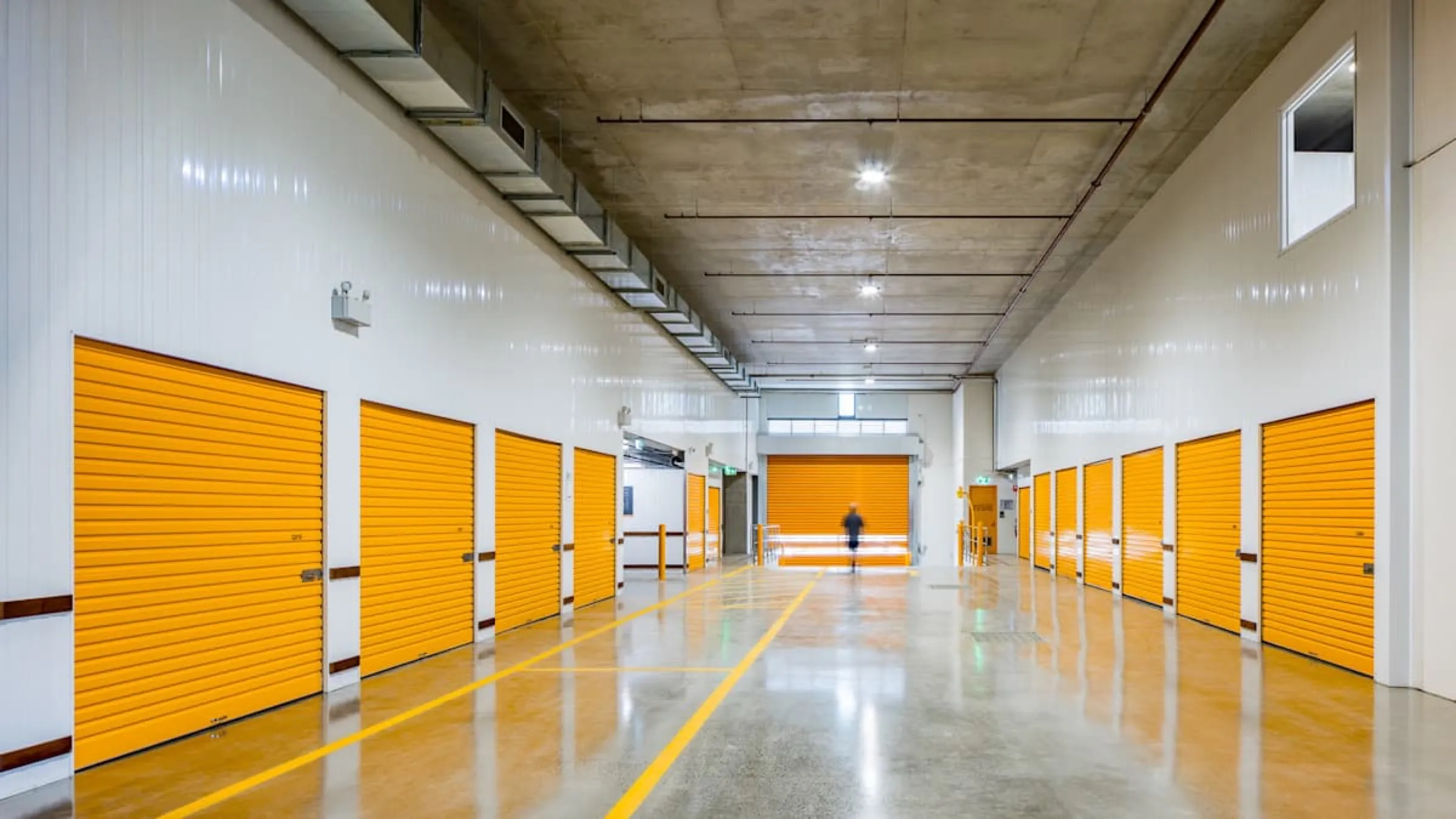 Internal drive-up corridor with yellow storage unit doors at Concord.